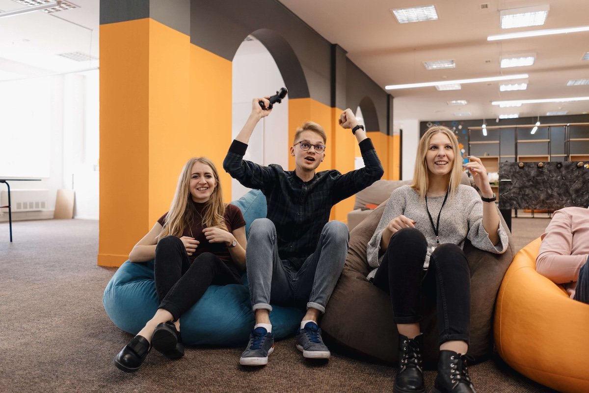 Team members celebrating success with emotional intelligence training at Mindklok